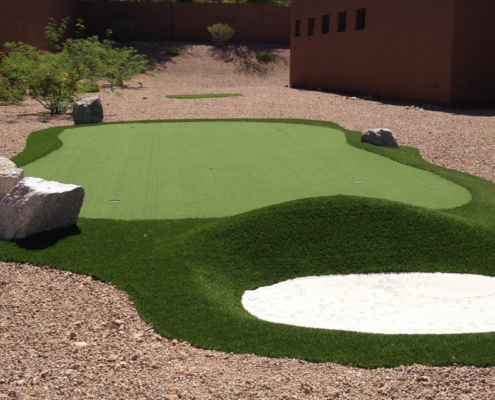 Backyard putting green with sand bunker.