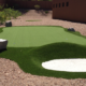 Backyard putting green with sand bunker.
