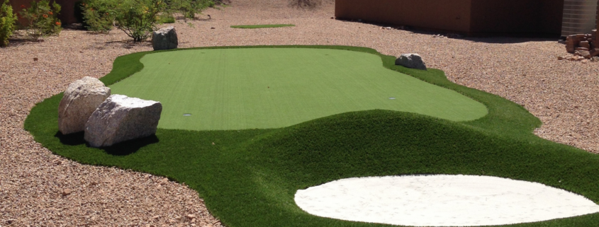 Backyard putting green with sand bunker.