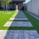 Backyard with turf and stepping stone path.