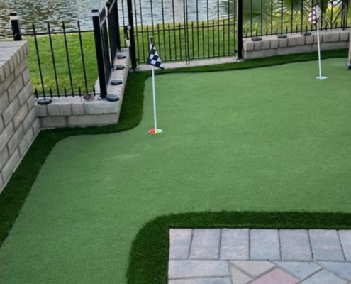 Backyard artificial turf putting green with flags