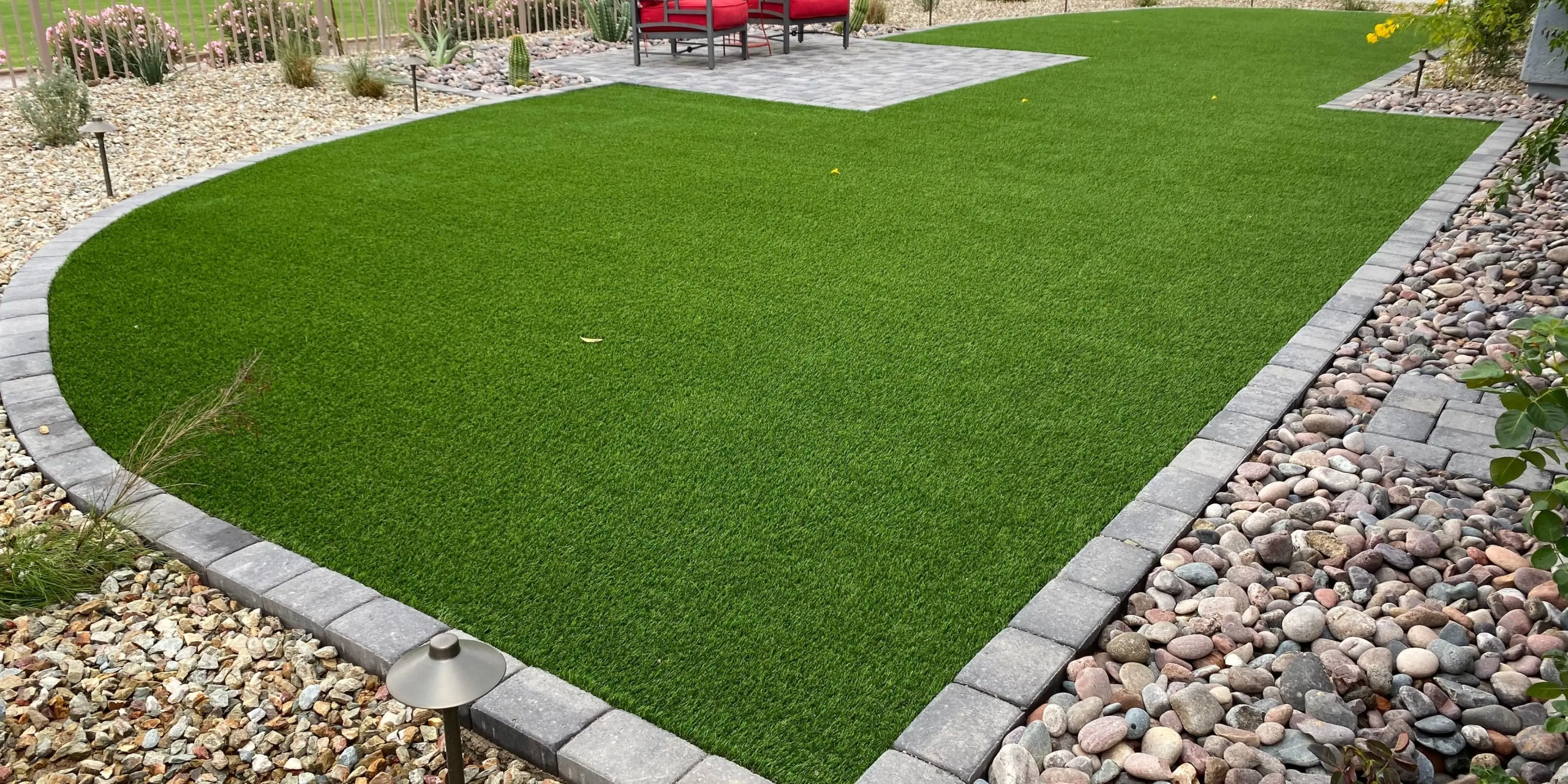 Artificial grass lawn with stone borders