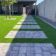 Stepping stone pathway through a green artificial grass
