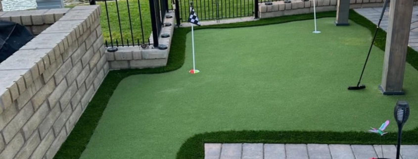 backyard putting green beside patio and lake view