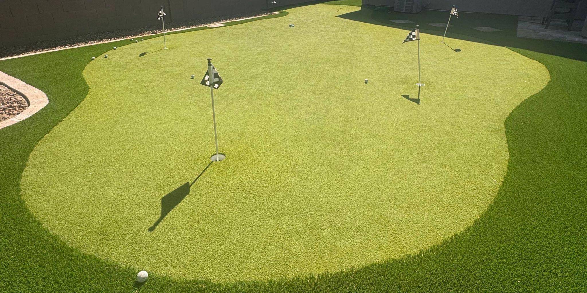Artificial turf golf putting green in backyard