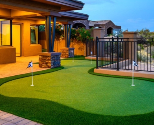 Modern backyard patio with a curved artificial putting green