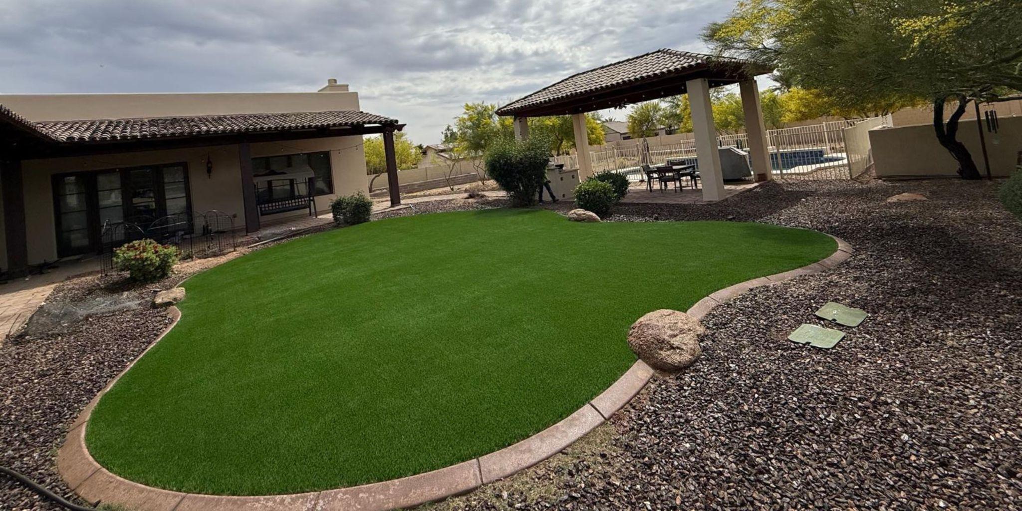 Artificial grass backyard with patio and gazebo.