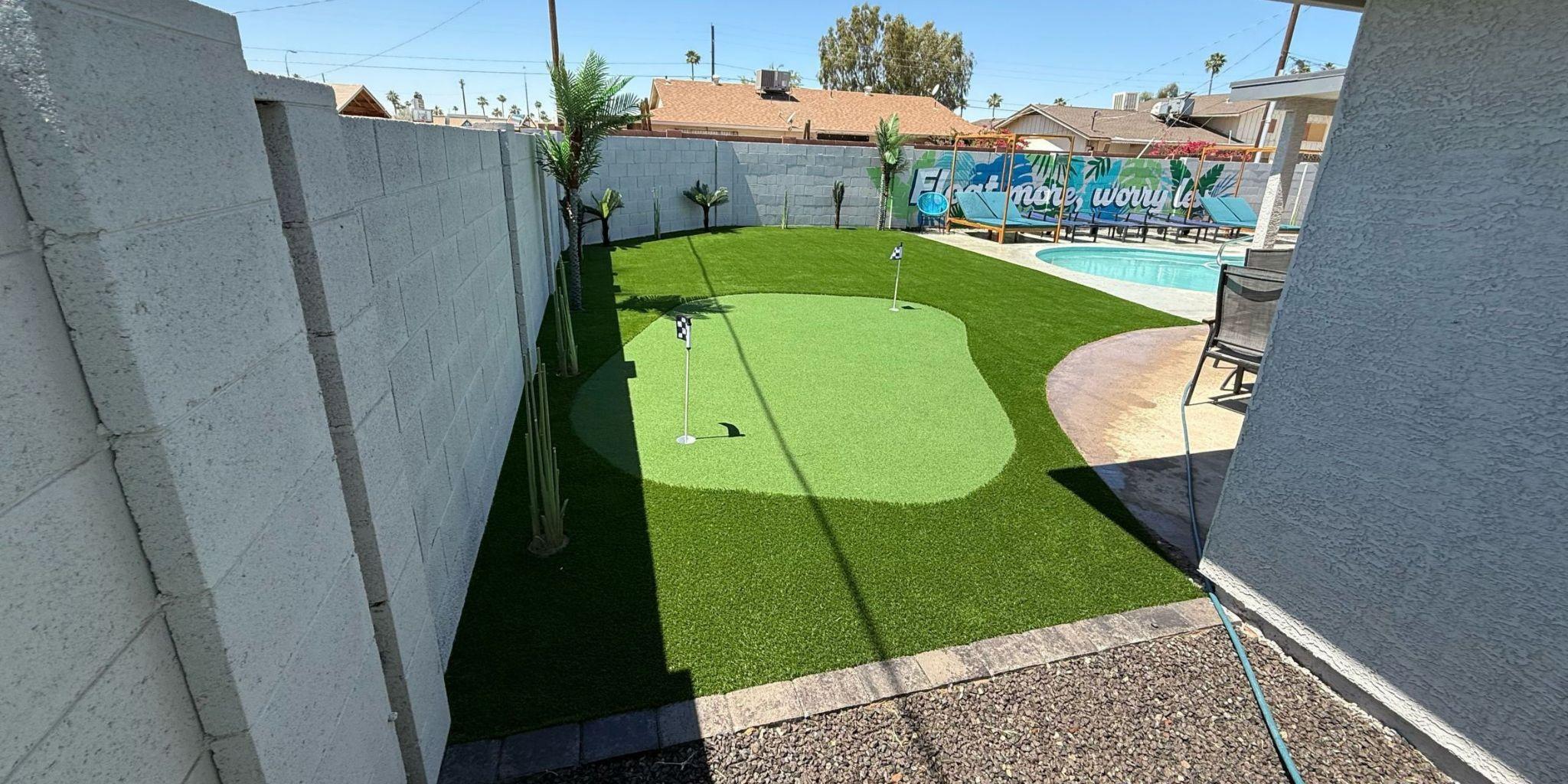 Artificial turf backyard with putting green