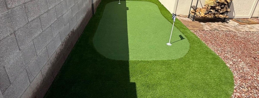 Backyard artificial turf putting green with two golf holes