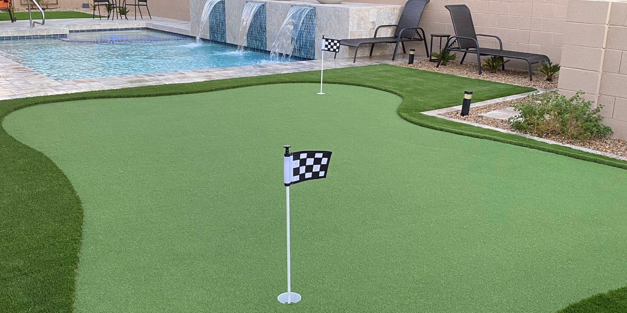 Backyard putting green beside a swimming pool