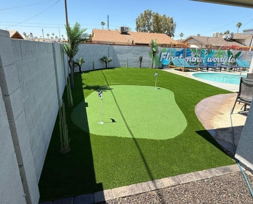 Backyard putting green with pool.