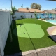 Backyard putting green with pool.