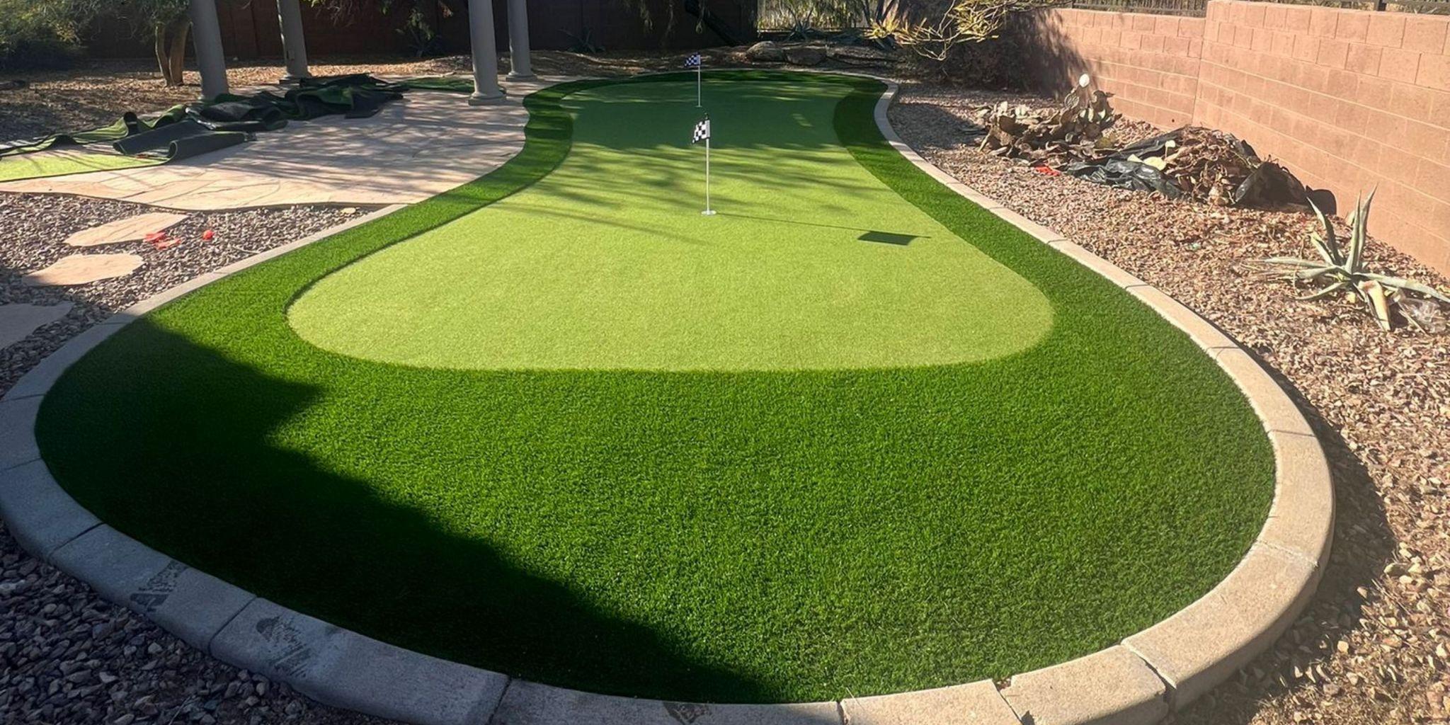 Long backyard artificial putting green with curved edges