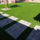 Stepping stones across a green lawn.