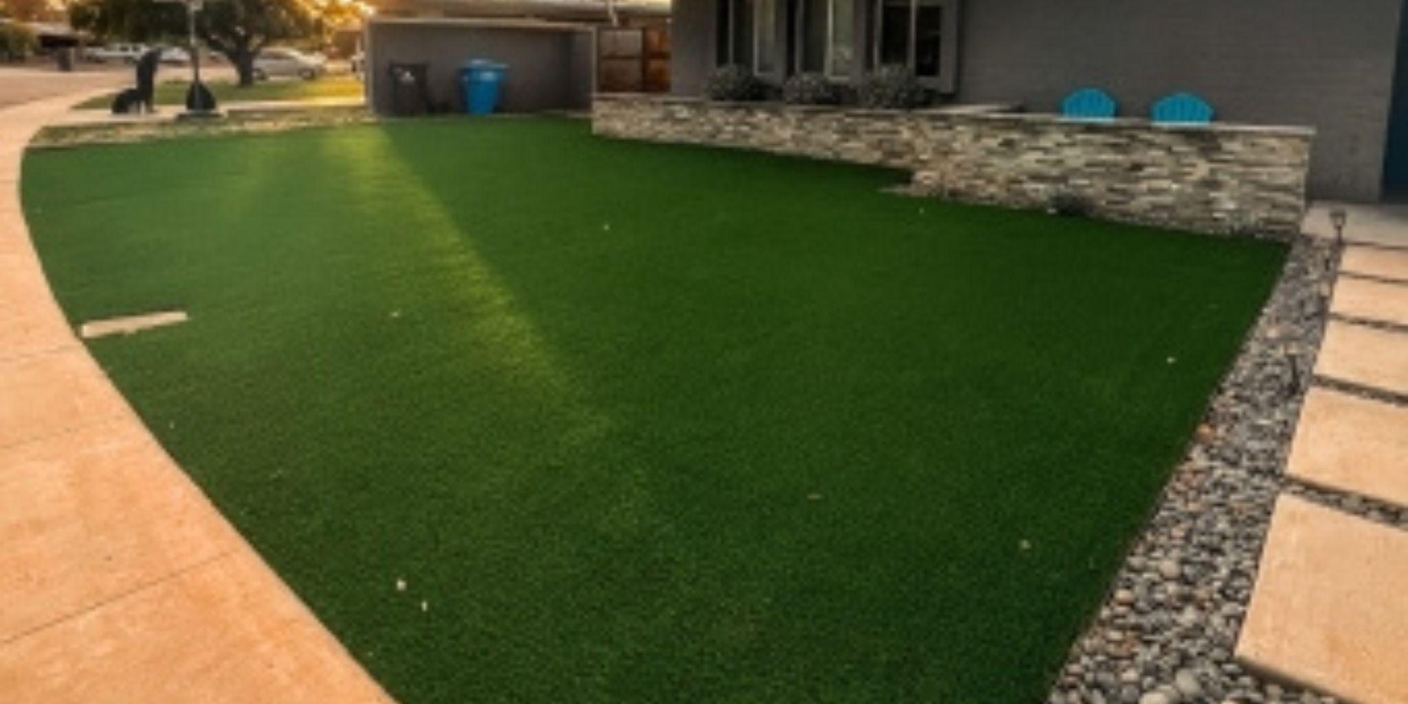 Artificial grass lawn bordered by a paved walkway
