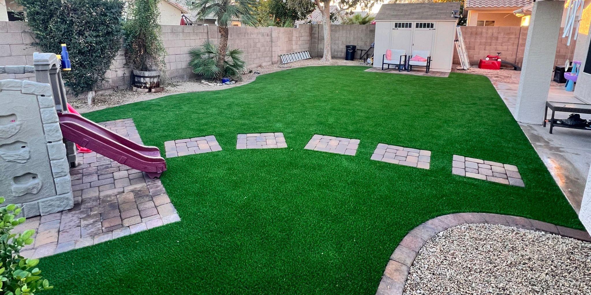 Backyard with artificial grass and stepping stones
