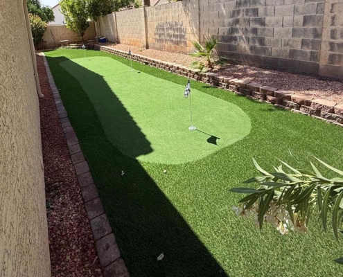 Backyard with artificial turf, a small putting green