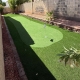 Backyard with artificial turf, a small putting green