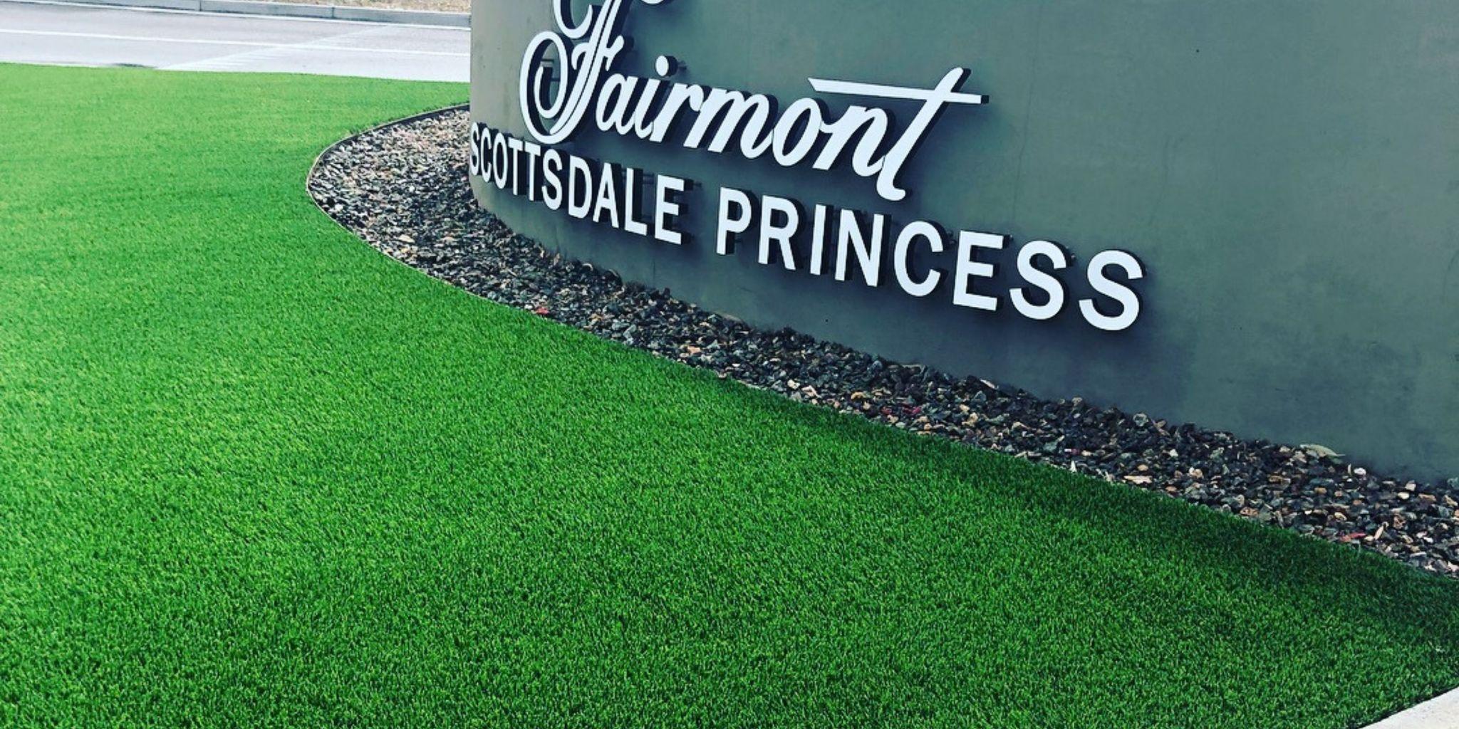 Fairmont Scottsdale Princess sign beside a green artificial lawn