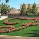 Landscaped fake grass lawn with red flower patterns