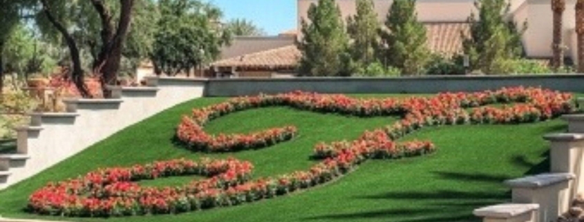 Landscaped fake grass lawn with red flower patterns