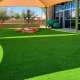 Outdoor artificial-turf play area with shade canopy