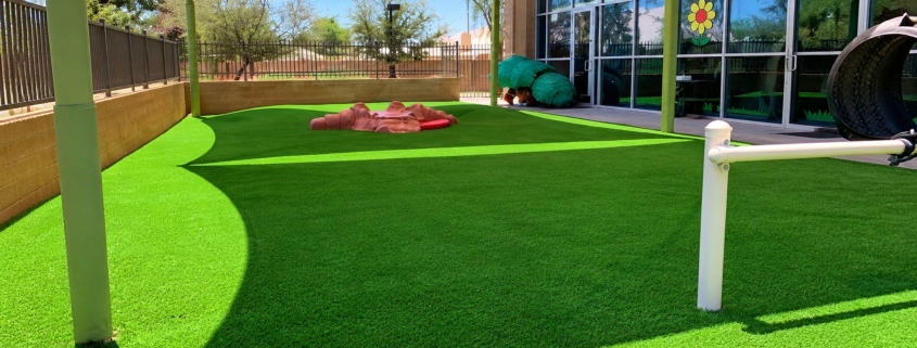 Outdoor artificial-turf play area with shade canopy