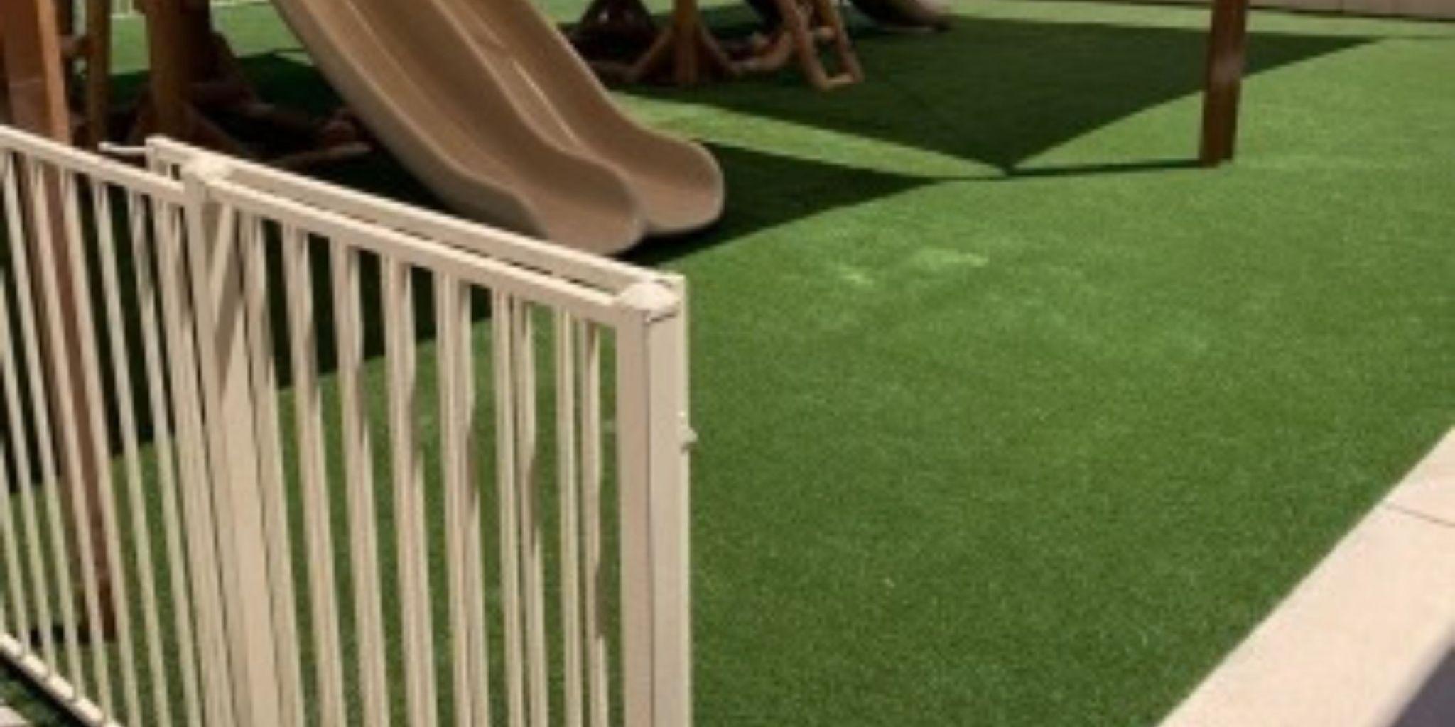 Playground with a slide, white fence