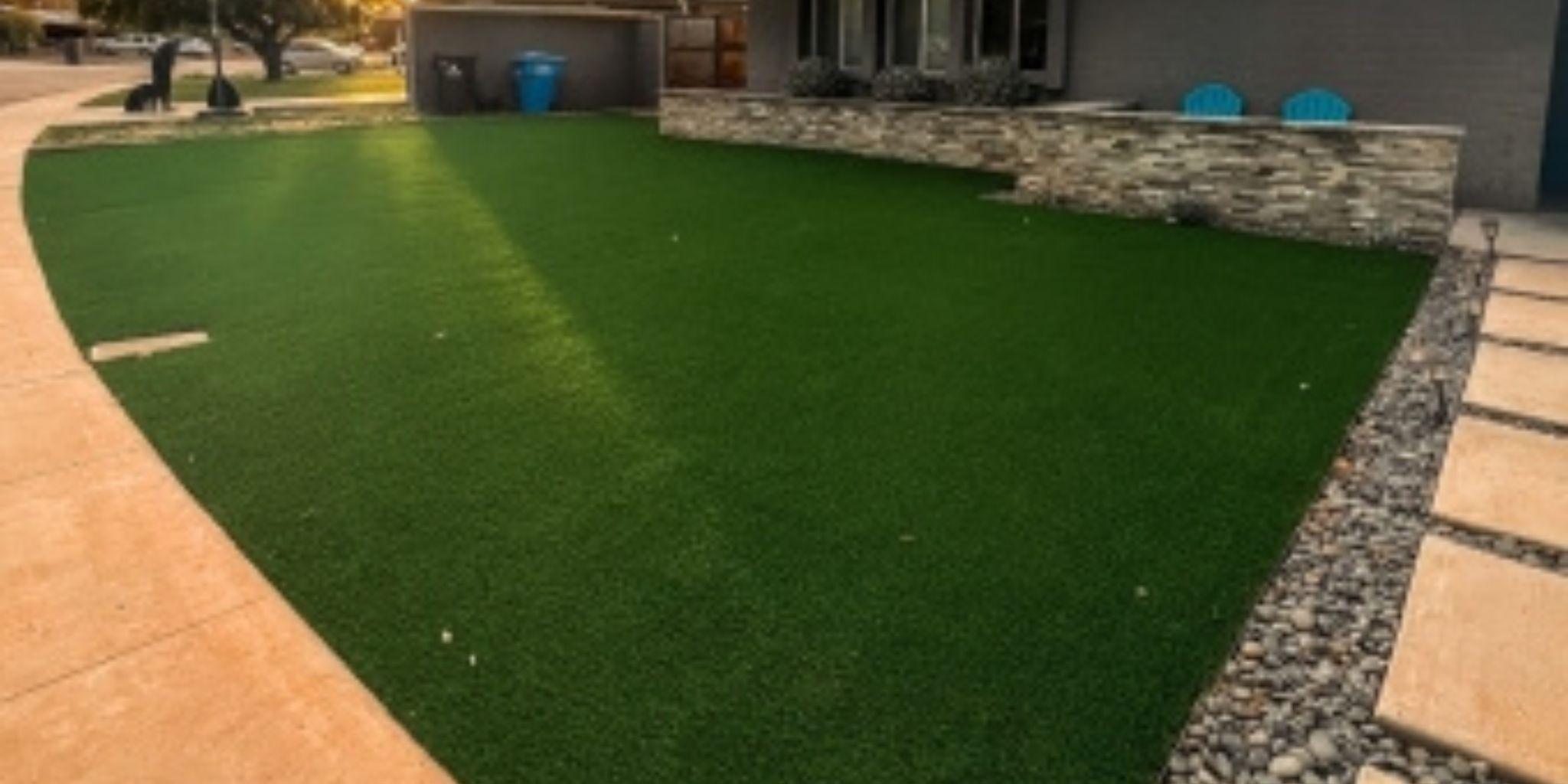 A lush artificial grass lawn bordered by a curved concrete walkway